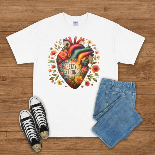 White Stay Strong floral anatomical heart T-shirt flat lay on brown wood with jeans and sneakers