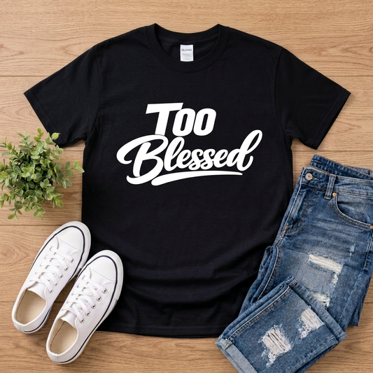 Black Too Blessed T-shirt with jeans and white sneakers on brown wood