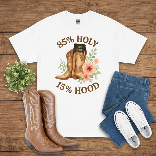 White 85% Holy 15% Hood graphic T-shirt on brown wood with jeans, boots, and white sneakers