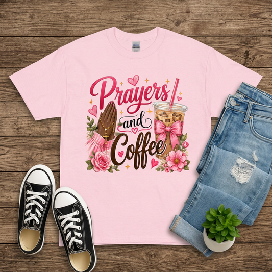 Pink Prayers and Coffee T-shirt flat lay on brown wood with jeans and black sneakers